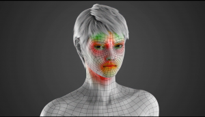 This is a 3D rendered image of the model from the facial animation in the middle of an intense facial expression. There are red and green colors on the face of the model indicating where the tension is in the face and where the wrinkles would occur. 