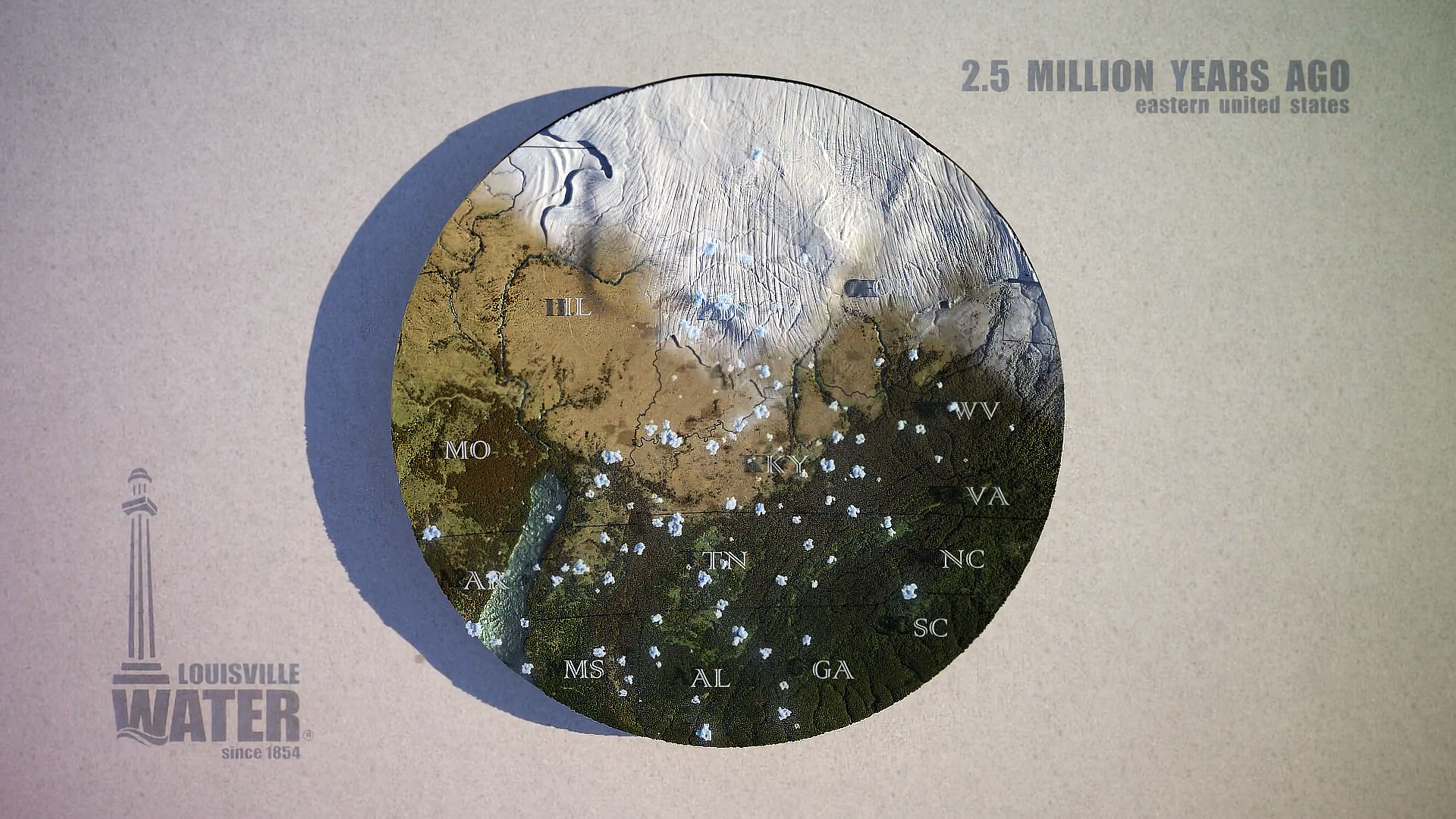 This 3D rendered image from a PR movie displays a circular chunk of land that represents the City of Louisville's region. Half of the land is being engulfed by glaciers it is demonstrating what occurred over 2.5 million years ago.